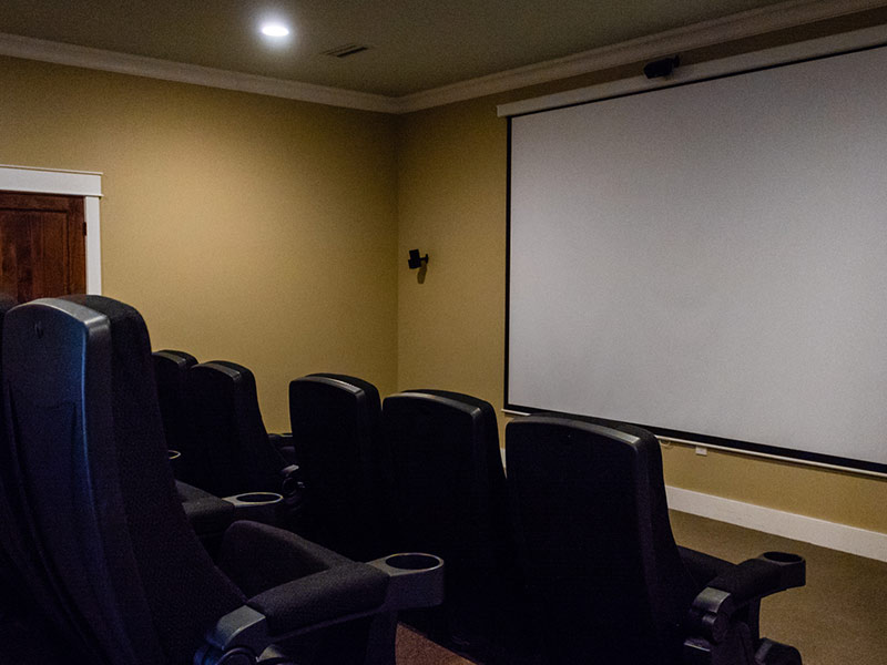 Private movie theater with theater style seating that accommodates up to 14 poeple.